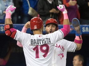 Toronto Blue Jays’ Jose Bautista celebrates with teammate Kevin Pillar after hitting a three-run home run against the Seattle Mariners in Toronto on Saturday, May 13, 2017. (THE CANADIAN PRESS/Fred Thornhill)