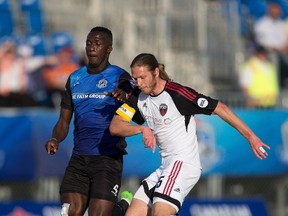 FC Edmonton's Abdoulaye Diakite and Ottawa Fury FC's Lance Rozeboom battle of the ball during the Canadian Championship quarterfinal game on Wednesday May 10, 2017, in Edmonton.