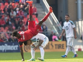 Toronto FC’s Tosaint Ricketts gets upended as he challenged for the ball with Minnesota’s Francisco Calvo yesterday. Ricketts continued his fine recent play by scoring the winner. The Canadian Press