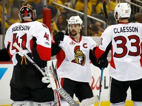 Erik Karlsson of the Ottawa Senators celebrates with Craig Anderson and Fredrik Claesson after defeating the Pittsburgh Penguins at PPG PAINTS Arena on May 13, 2017 in Pittsburgh. (Gregory Shamus/Getty Images)