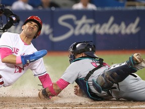 Devon Travis of the Toronto Blue Jays steals home plate in the eighth inning as Carlos Ruiz of the Seattle Mariners tries to tag him at Rogers Centre on May 13, 2017. (TOM SZCZERBOWSKI/Getty Images)