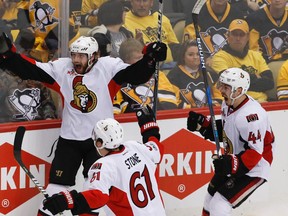 Senators' Bobby Ryan (back) celebrates his overtime winner against the Penguins in Pittsburgh on Saturday night. (The Associated Press)