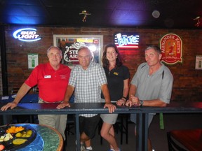 It’s seldom that busy Kelly and Bruce O’Hare and Rob Norris, who own the Anchor Inn together, are in the same place at the same time. On the left is Cruisers’ Net Host Roy Eaton, Bruce and Kelly O’Hare, and Rob Norris. These four stand still for one minute at a Cruisers’ Net cocktail party.  Who said Manitouliners aren’t  busy?
