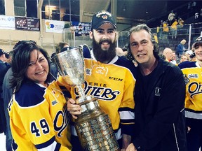 Cameron Lizotte and his parents, Lise and Paul, celebrate with the J. Ross Robertson Cup after Lizotte and his teammates from the Erie Otters won the title on Friday. Photo supplied.