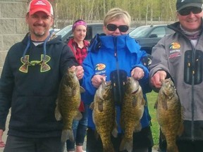 Greater Sudbury's Mike Gifford (right) and Kerry Dalcourt (middle) pose with their winning from Ramsey Lake on Saturady. Nickel City Bass club Frank Clark (left) helped the couple phot all their fish. Bruce Heidman
