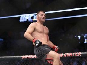 Stipe Miocic celebrates a win over Junior Dos Santos for the heavyweight championship at UFC 211 in Dallas on Saturday, May 13, 2017. (AP Photo/Gregory Payan)
