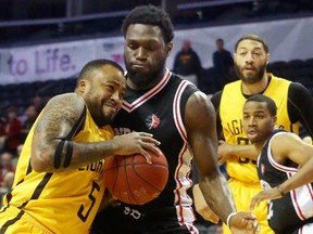The London Lightning's Junior Cadougan drives in hard on Windsor's Juan Pattillo during their second playoff game Sunday May 14, 2017 at Budweiser Gardens. The Lightning squeaked out a 106-105 win on a buzzer beater by Garett Williamson.  Mike Hensen/The London Free Press/Postmedia Network