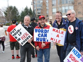 Jessica Laws/For The Intelligencer
Men donned high heels for Walk a Mile in her Shoes in downtown Belleville on Saturday. The annual walk raises funds for the Three Oaks Shelter and raises awareness of domestic violence against women. Pictured are Mark Rollins, Mayor Taso Christopher and councillors Egerton Boyce and Jack Miller.