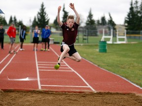 Logan Clow/Daily Herald-Tribune
Seth Martens, 13, makes a long jump leap during the Peace Country Wolves Athletics Club’s annual Peace Country Classic Track and Field Meet on Saturday at Legion Field in Grande Prairie. Despite wet and cold temperatures, there were 81 registrants for the event.