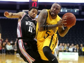 Junior Cadougan of the London Lightning drives past Maurice Jones of the Windsor Express in the fourth quarter of of Game 2 of their NBL of Canada Central Division best-of-seven final Sunday at Budweiser Gardens. The Lightning won 106-105 to take a 2-0 series lead. (MIKE HENSEN, The London Free Press)