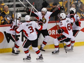 Senators' Bobby Ryan (centre) celebrates with teammates Marc Methot (3), Derick Brassard (19), Mark Stone (61) and Jean-Gabriel Pageau (44) after scoring the game-winning goal against the Penguins during the first overtime period of Game 1 of the NHL's Eastern Conference final in Pittsburgh on Saturday, May 13, 2017. (AP Photo/Gene J. Puskar)