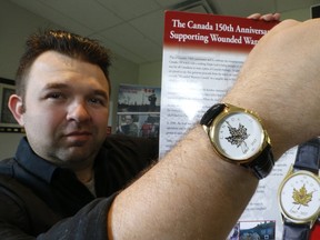 David Macdonald, of Wounded Warriors Canada, shows off a watch that has been created to celebrate Canada and to provide a means to donate to Wounded Warriors Canada. (MICHAEL PEAKE/TORONTO SUN)