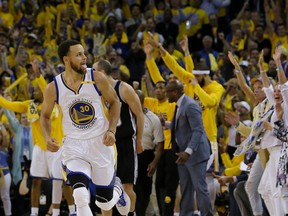 Warriors guard Stephen Curry (30) reacts after scoring against the Spurs during the second half of Game 1 of the NBA's Western Conference final in Oakland, Calif., on Sunday, May 14, 2017. (AP Photo/Jeff Chiu)