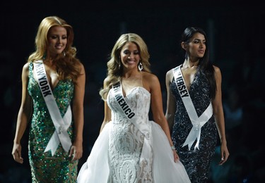 In this May 11, 2017, photo, Miss New Jersey USA Chhavi Verg, right, competes during a preliminary competition for Miss USA in Las Vegas. Verg emigrated from India with her parents. Five of the contestants vying for the Miss USA title this year were born in other countries and now U.S. citizens. (AP Photo/John Locher)
