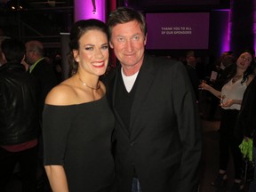 World featherweight boxing champion Jelena Mrdjenovich poses for a photo with Wayne Gretzky at at the premiere of a documentary about her boxing career held at the Art Gallery of Alberta earlier this year. (File)