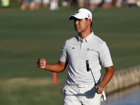 Si Woo Kim of South Korea celebrates on the 18th green after finishing 10 under to win during the final round of THE PLAYERS Championship at the Stadium course at TPC Sawgrass on May 14, 2017 in Ponte Vedra Beach, Florida. (Photo by Sam Greenwood/Getty Images)