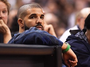 Rapper, Drake, watches the action between the Toronto Raptors and the Cleveland Cavaliers during the second half of game three of an NBA playoff series basketball game in Toronto on Friday, May 5, 2017. THE CANADIAN PRESS/Frank Gunn