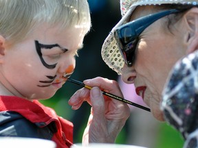 Mitchell’s Andrew Bauer, who turns three-years-old in a few weeks, gets the finishing touches put on his “cat” face paint by Jennifer Black, of Goderich, during the 16th annual Mitchell Kinette Rubber Duck race held last Saturday, May 13 at Howie Morenz Memorial Gardens. ANDY BADER/MITCHELL ADVOCATE