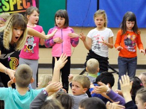 Sara Westbrook (left) brought her UPower motivational message to St. Patrick’s School in Dublin last Thursday, May 11, where some students had the chance to play in an imaginery air band. ANDY BADER/MITCHELL ADVOCATE