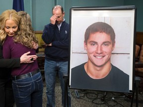 Centre County District Attorney Stacy Parks Miller, left, hugs Evelyn Piazza as her husband Jim stands in the background after announcing the findings in the investigation of the February death of the couple’s son, Timothy Piazza, seen in photo at right, at Penn State University’s fraternity Beta Theta Pi, Friday, May 5, 2017, in Bellefonte, Pa. (Joe Hermitt /PennLive.com via AP)