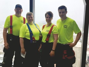 Champion firefighters  Dewy de Vries, left, Lorae Tompkins, Catherine Pooley and Nolan Perley  climbed Calgary’s Bow tower May 7 in full firefighter gear. Another Champion firefighter, Joel Nygren, also climbed the 1,204 steps.