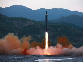 This May 14, 2017, photo distributed by the North Korean government shows the "Hwasong-12," a new type of ballistic missile at an undisclosed location in North Korea. North Korea on Monday boasted of a successful weekend launch of a new type of "medium long-range" ballistic rocket that can carry a nuclear warhead. Independent journalists were not given access to cover the event depicted in this photo. (Korean Central News Agency/Korea News Service via AP)