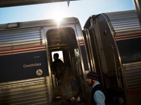 In this Nov. 23, 2016, file photo, passengers board an Amtrak train heading to New Orleans in Atlanta. (AP Photo/David Goldman, File)