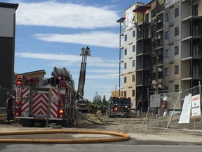 Welding work is being blamed for a two-alarm fire that ripped through a portion of a residential development under construction next door to the new Outlet Collection  on Sterling Lyon Parkway in Winnipeg on Monday, May 23, 2017. Winnipeg Fire Paramedic Service Chief John Lane said the service received multiple calls around 2 p.m., of a fire breaking out at 701 Sterling Lyon Pkwy., and approximately 20 fire, ambulance and officer units responded. Lane said the welding activity ignited material at the base of the building and quickly "raced up" the six-storey structure, Lanes said the construction crew evacuated quickly and no injuries were reported. DAVID LARKINS/Winnipeg Sun/Postmedia Network