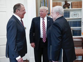 U.S. President Donald Trump meets with Russian Foreign Minister Sergey Lavrov, left, next to Russian Ambassador to the U.S. Sergei Kislyak at the White House in Washington, Wednesday, May 10, 2017. Trump on Wednesday welcomed Vladimir Putin's top diplomat to the White House for Trump's highest level face-to-face contact with a Russian government official since he took office in January. (Russian Foreign Ministry Photo via AP)