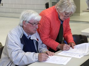 BRUCE BELL/THE INTELLIGENCER
Retired County surgeon Earl Taylor and his wife Joan fill out surveys at the PECMH Site Selection Community Consultation open house in Picton on Monday.
