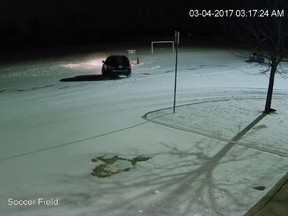 An image from surveillance video provided by Stoneycreek Baptist Church shows an SUV spinning in circles on a soccer field behind the church.