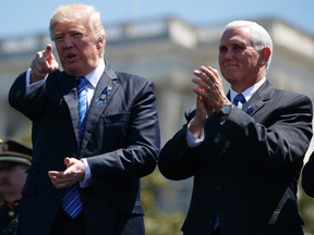 U.S. President Donald Trump stands with Vice President Mike Pence during the 36th annual National Peace Officers Memorial Service on Capitol Hill in Washington on Monday, May 15, 2017. (AP Photo/Evan Vucci)