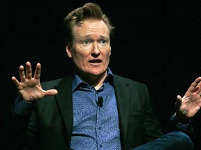 In this Feb. 12, 2016 file photo television host Conan O'Brien gestures to the audience at Sanders Theatre on the campus of Harvard University in Cambridge. O'Brien is vigorously defending himself from plagiarism allegations by a writer who accused him of ripping off punchlines about Caitlyn Jenner, Tom Brady and the Washington Monument. (AP Photo/Charles Krupa,File)