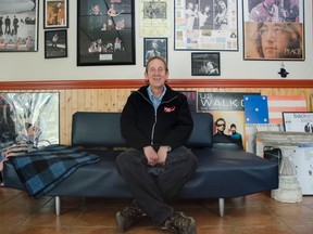 David Finlay sits in front of some of his collection of concert posters and newspaper articles. (Gracie Postma/For The Whig-Standard)