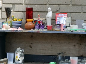The remains of a memorial on Compton Street on Sunday pay respects to four victims of a fatal pileup on Highway 401 last week.  (Steph Crosier/Whig-Standard file photo)