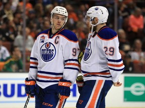 Edmonton Oilers captain Connor McDavid, left, speaks with Leon Draisaitl during Game 2 of the Western Conference second-round playoff series against the Anaheim Ducks at Honda Center on April 28, 2017, in Anaheim, Calif. (Getty Images)