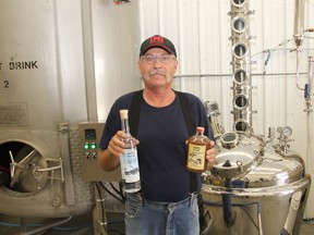 Back 40 Distillery co-owner Lorne Haugen shows off their two spirits they produce,Winter Time Frost Vodka, and Ol' Apple Betty in Camrose, Alta. on Friday May 5, 2017. Josh Aldrich/Camrose Canadian/Postmedia Network