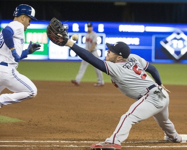 The Braves' 1st baseman fails to snag the throw in the 4th to get Devon Travis as Travis goes on to score Toronto's 2nd run,  as the Toronto Blue Jays host the Atlanta Braves in Toronto, Ont. Throwing error for shortstop Dansby SwansonTuesday May 16, 2017. Stan Behal/Toronto Sun/Postmedia Network