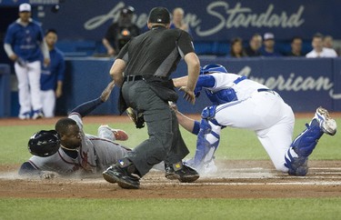 The Braves Adonis Garcia dives into home in the 2nd inning to score the Braves' 3rd run for Atlanta,  as the Toronto Blue Jays host the Atlanta Braves in Toronto, Ont. on Monday May 15, 2017. Stan Behal/Toronto Sun/Postmedia Network ORG XMIT: POS1705151917256219