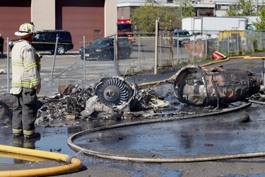 A firefighter stands looks over the scene after a jet crashed into a building near Teterboro Airport in Carlstadt, N.J., Monday, May 15, 2017. (Aristide Economopoulos/NJ Advance Media via AP) ORG XMIT: NJNEW201