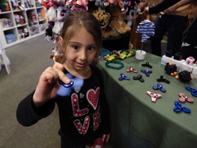 In this Thursday, May 11, 2017, photo, Penelope Daversa, 4, plays with a fidget spinner at the Funky Monkey Toys store, in Oxford, Mich. Stores can’t keep them in stock and parents are going crazy trying to find them. (AP Photo/Carlos Osorio)