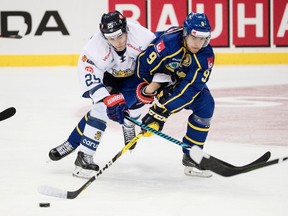 Finland's Henrik Haapala, left, and Sweden Calle Rosen vie during the Sweden Hockey Games match at the Scandinavium Arena in Goteborg, Sweden, on Feb. 12, 2017. (BJORN LARSSON ROSVALL/AFP/Getty Images)