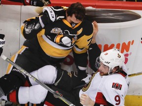 Pittsburgh Penguins' Evgeni Malkin, top, and Ottawa Senators' Bobby Ryan hit the ice during Game 2 at PPG Paints Arena on May 15, 2017. The Penguins won 1-0. (AP Photo/Gene J.Puskar)