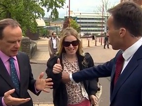 Ben Brown of the BBC grabs an unidentified woman by the breast during a live interview with colleague Norman Smith. (YouTube screen grab)