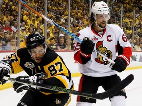 Pittsburgh Penguins' Sidney Crosby and Ottawa Senators' Erik Karlsson look for the puck from along the boards during Game 2 at PPG Paints Arena on May 15, 2017. (AP Photo/Gene J.Puskar)