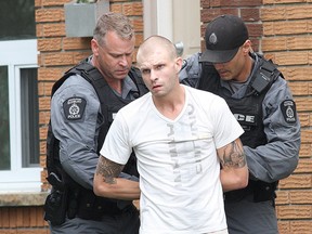 A Greater Sudbury Police tactical unit makes an arrest on Bruce Avenue in Sudbury, Ont. on Friday August 12, 2016. John Lappa/Sudbury Star/Postmedia Network