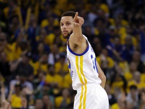 Golden State Warriors' Stephen Curry signals after scoring against the San Antonio Spurs during the first half of Game 2 of the NBA basketball Western Conference finals, Tuesday, May 16, 2017, in Oakland, Calif. (AP Photo/Marcio Jose Sanchez)