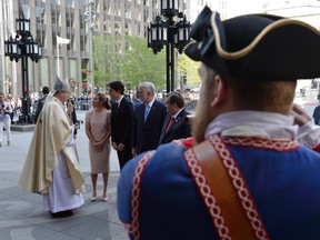 The Prime Minister Justin Trudeau and Ms. Gregoire Trudeau, Premier of Quebec Philippe Couillard and Mayor Coderre meet with Archbishop of Montreal, Rev. Christian Lepine as they walk to the Notre-Dame Basilica to attend a mass marking the 375th anniversary of the founding of Montreal on Wednesday May 17, 2017. (THE CANADIAN PRESS/Paul Chiasson)