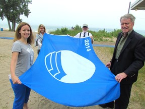 Sarnia's Canatara Park Beach has again been designated as one of Canada's Blue Flag beaches, after meeting the requirements for the international program. In this file photo, from left, Brett Tryon, with the Blue Flag program, Shelley Erwin with the city's parks and recreation department, former city Coun. Terry Burrell and Mayor Mike Bradley hold the first Blue Flag awarded to Canatara in 2014. (File photo/ THE OBSERVER)