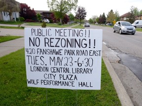 Opponents have posted a sign urging attendance at a public meeting about the possible rezoning of 420 Fanshawe Park Rd. E. in north London to allow construction of a four-storey apartment building. (MORRIS LAMONT, The London Free Press)
